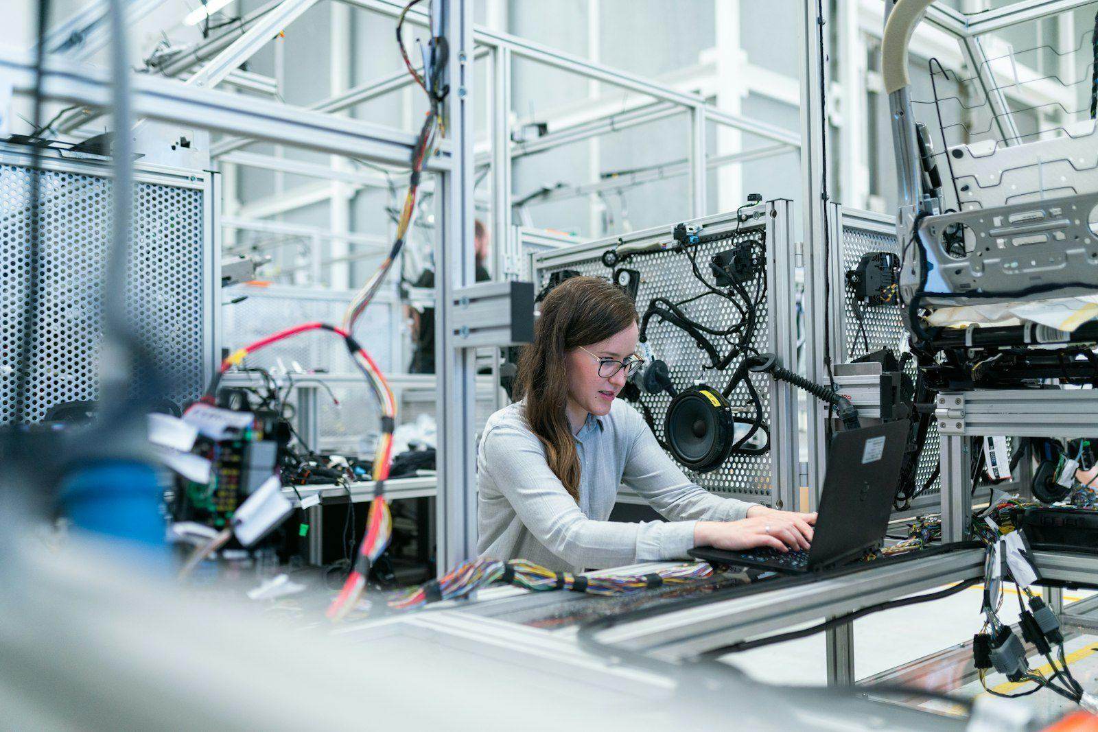 Quality control inspector reviewing component measurements on the production line at a verified factory in Guangdong.